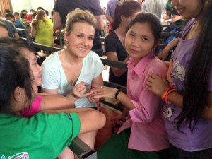 Kristin sharing her fingernail polish with a student